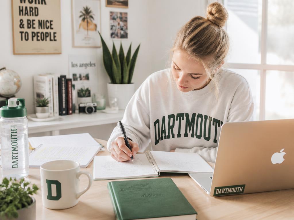 Student focused on a laptop during a late study session
